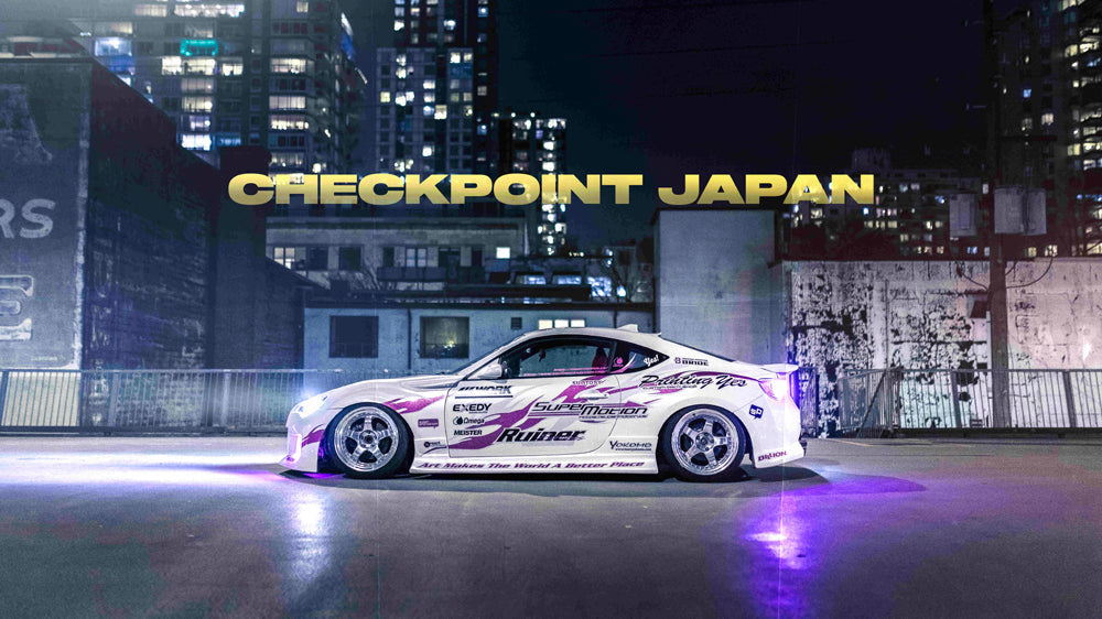 Marcus Lam BRZ with a new livery at night with a lit up city behind it.
