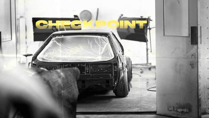 Title card with the word "Checkpoint" black and white image of Dylan's kaido racer Supra in the paint booth.