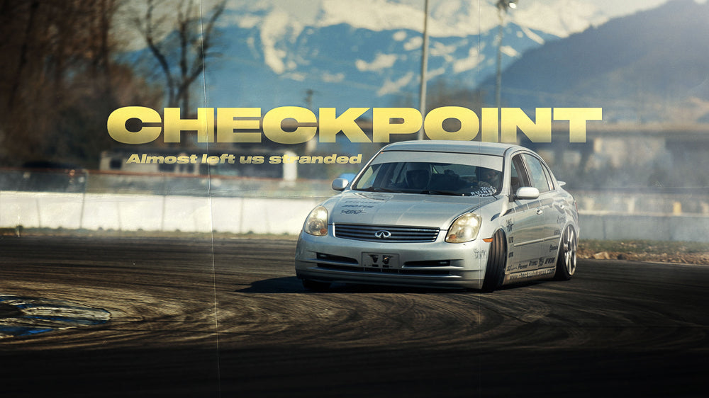 Checkpoint's silver G35 sedan drift car sliding around a corner at Mission Raceway Park.