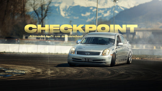 Checkpoint's silver G35 sedan drift car sliding around a corner at Mission Raceway Park.