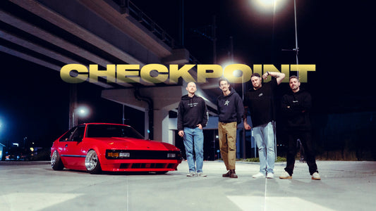 Reid, Sam, Dylan and Alex standing beside the red XX Supra in Tacoma, Washington.