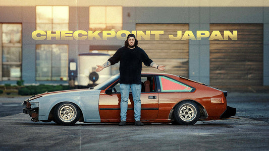 Dylan stands in front of his kaido racer MK2 Toyota Supra with his hands outstretched. 