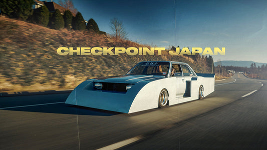 Reid from Checkpoint's Rudeboy Custom X7 Toyota Cressida silhouette kaido racer build being driven down a two lane road.