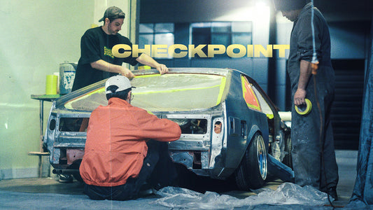 Three men working on a MK2 Toyota Supra.