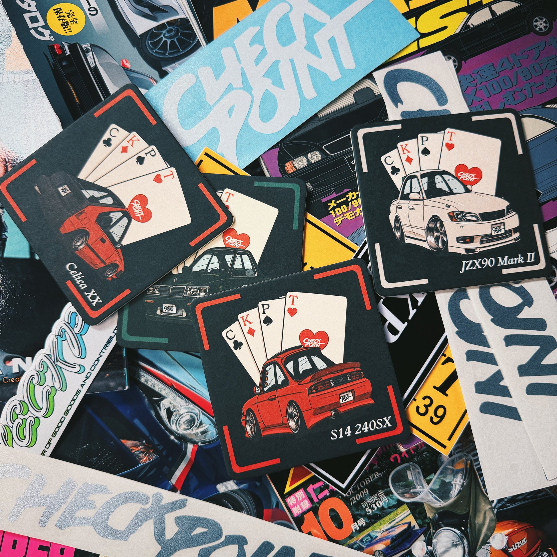 A dense, overlapping collage of stickers and printed decals featuring the word 'CHECK POINT' in various colors and designs, many with illustrations of cars and playing cards.